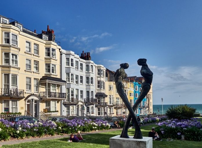 Hove, Building in Regency Square, Tay sculpture by Romany Mark